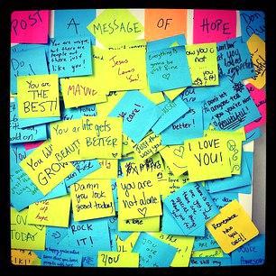 messages of support on colorful sticky notes