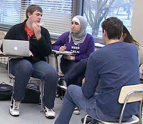 4 students discussing in a group