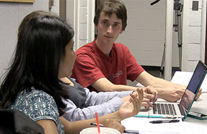 3 students discussing in a group