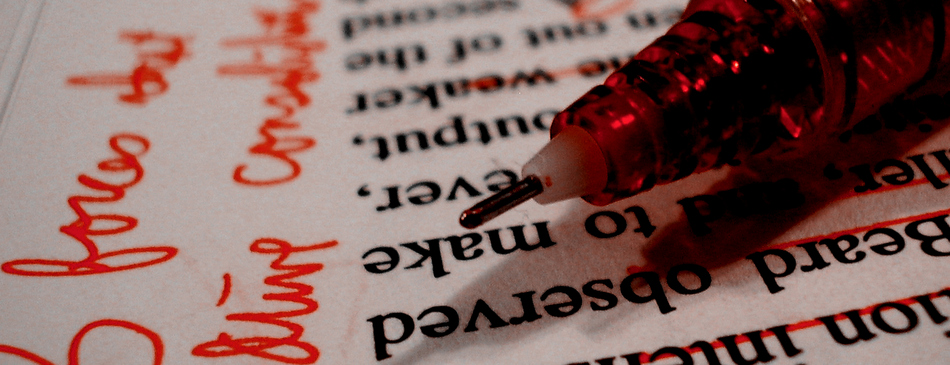 red pen with graded paper
