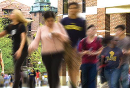 Blurred photo of students walking on campus