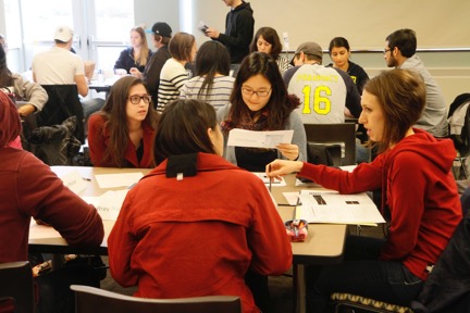 Students seated in groups working on an assignment