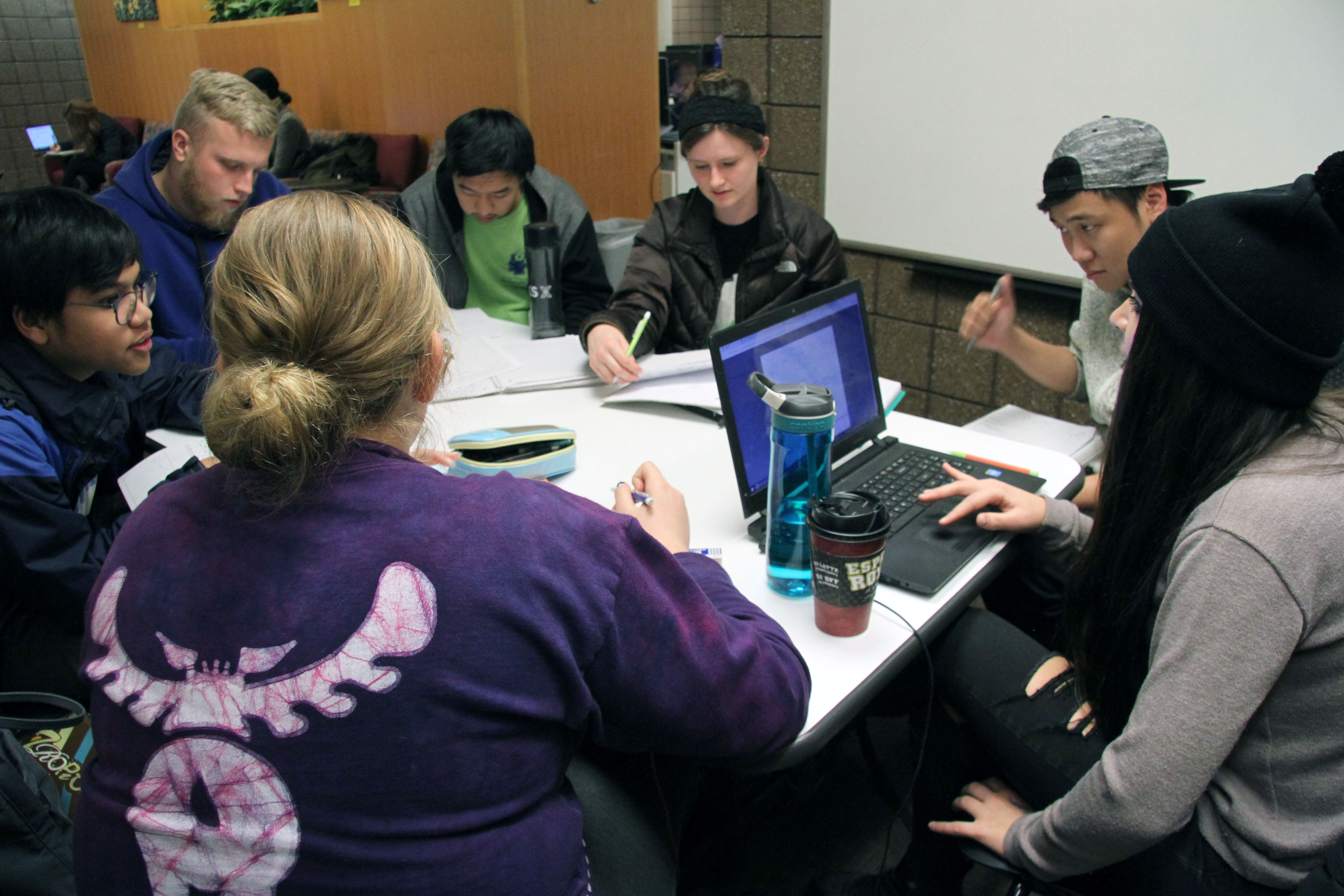 Students working in a group around a table