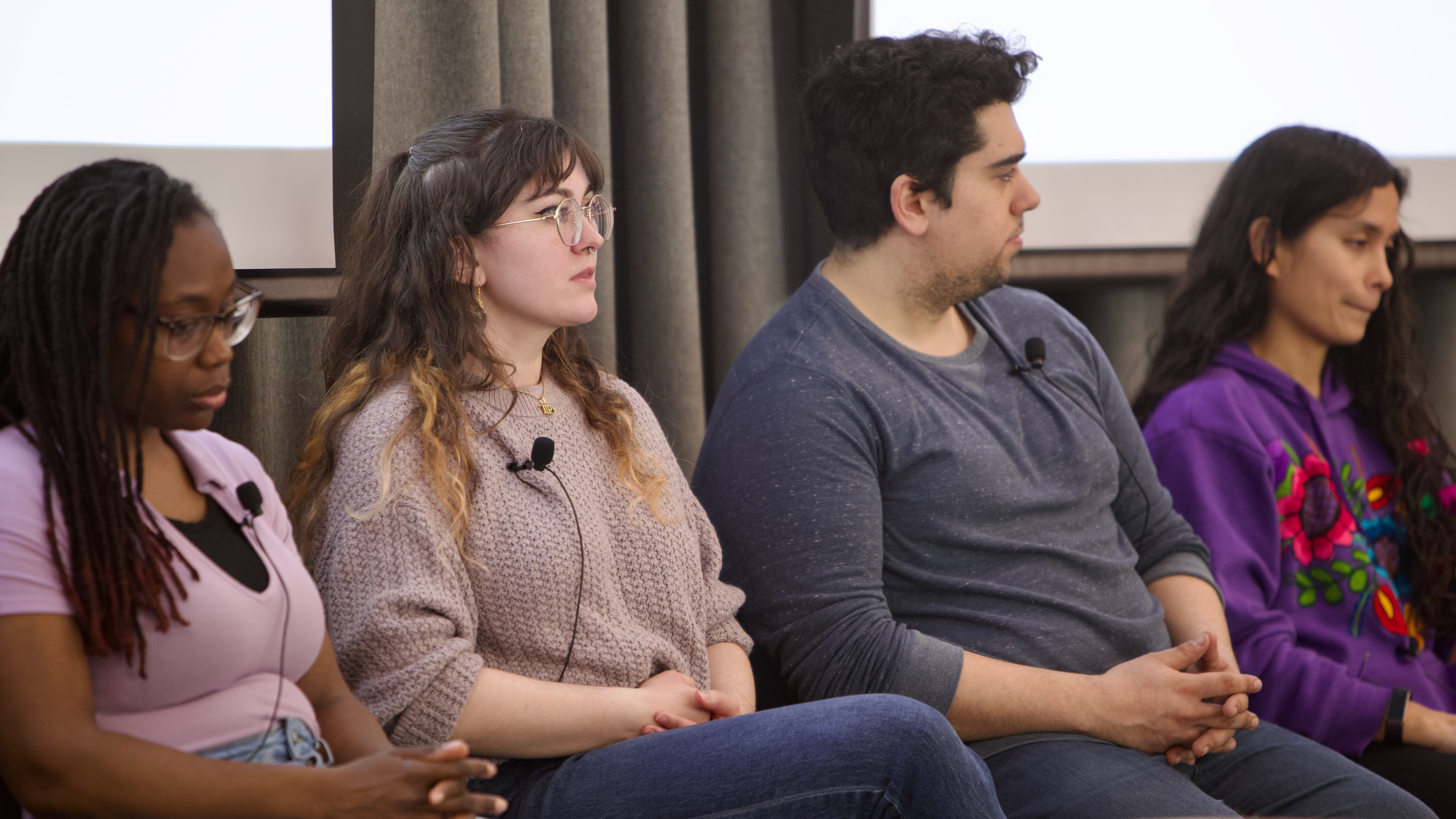 Four actors seating down next to each other
